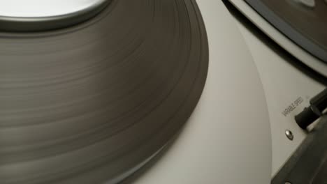 close-up of a vintage record player with spinning records