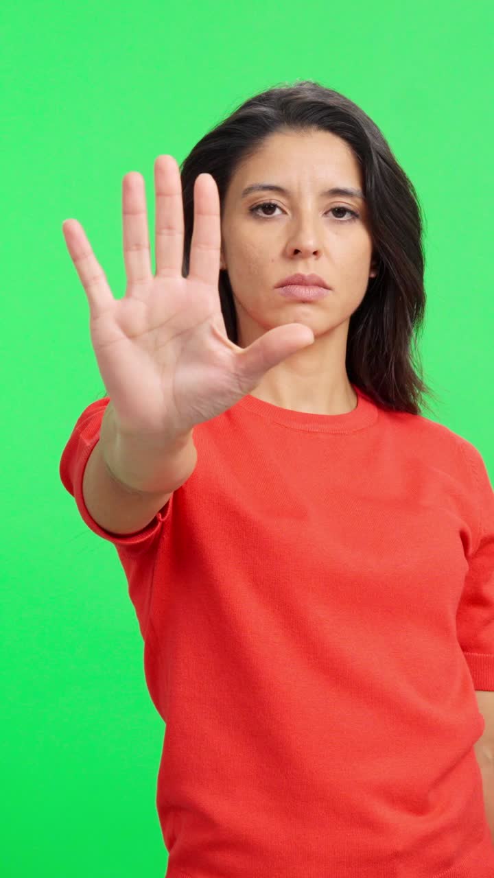 Serious Woman Making Stop Hand Gesture on Green Screen