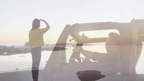 waving at driver in convertible, person enjoying ocean view during sunset
