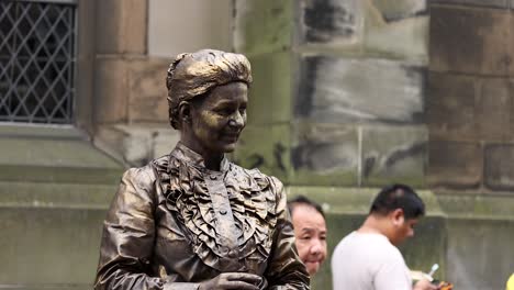 street performer in bronze costume at edinburgh festival