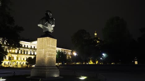 nighttime view of a statue in a city park