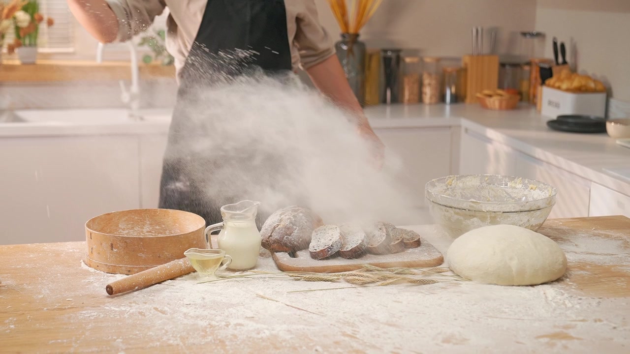 Baker Throwing Flour in Modern Kitchen with Baking Ingredients