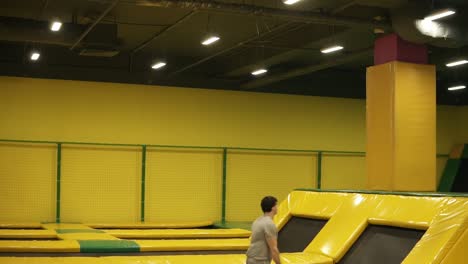unbelievable back double somersaults one after one performed by professional young male athlete on the trampoline.
