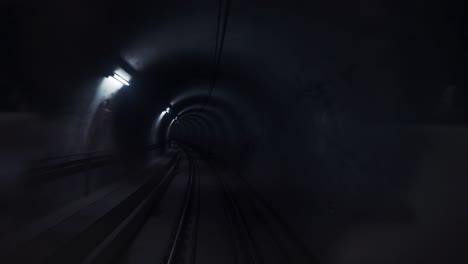 dark underground subway tunnel with lanterns on the walls. modern city transport