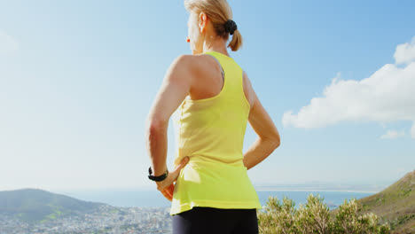 Senior-woman-standing-with-hand-on-hip-at-countryside-4k