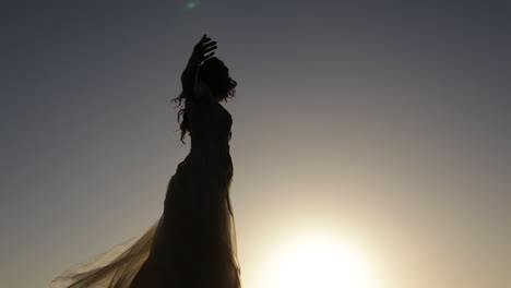 silhouette of girl dancing in sunset