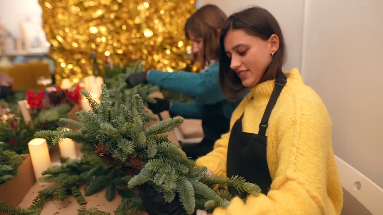 Women Crafting Christmas Wreaths