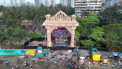 people are sitting and watching the program at dadar chow patty beach bird eye wide to closeup view mumbai