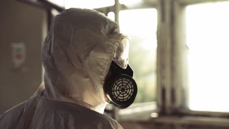 worker in protective suit inside the ruined building, close up