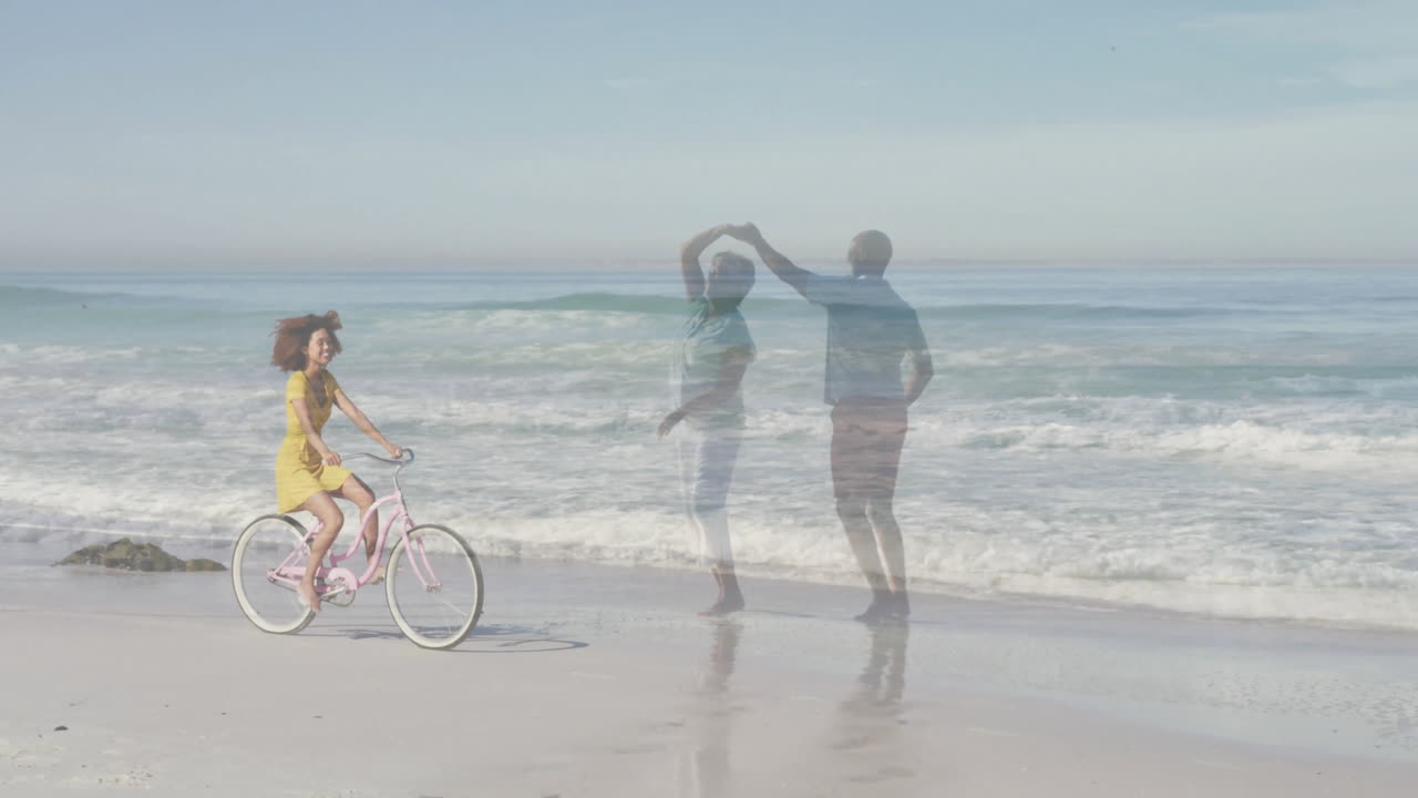 woman cycling pink bicycle on shoreline with dancing couple overlay and ocean waves for marketing