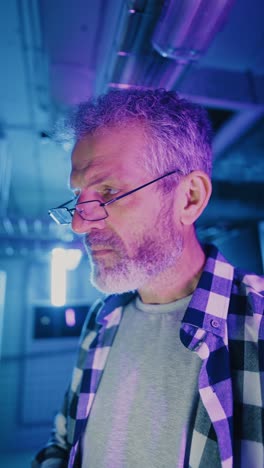 focused man in a server room