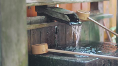 traditional chozubachi hand washing fountain basin at the fushimi inari shrine in kyoto, japan