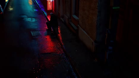 lonely figure in a rainy alley at night