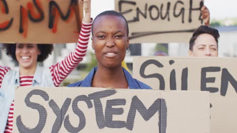 Diverse-group-of-protesters-holding-cardboard-banners-and-screaming