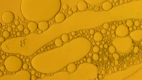 fondo de gotas de aceite abstracto en líquido dorado para tratamientos cosméticos hidroge