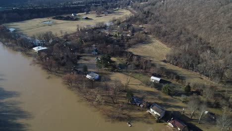 aerial top down view of american homes in kentucky neighborhood flooded river in winter