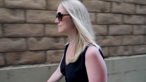 front to backwards follow of a woman walking in a parking garage