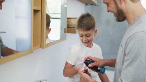 hombre caucásico y su hijo en el baño