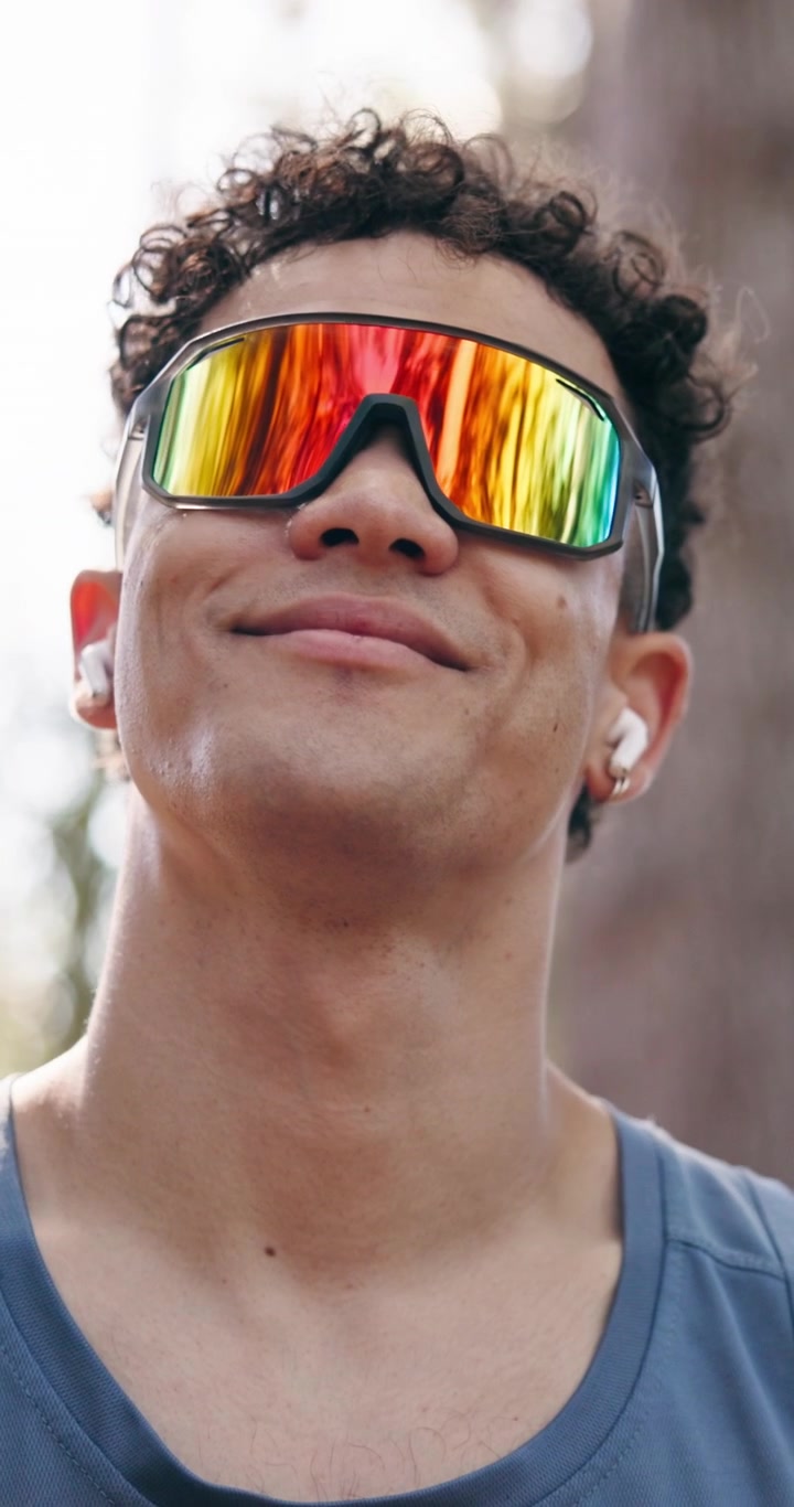 Young Man Wearing Sport Sunglasses and Earbuds Outdoors