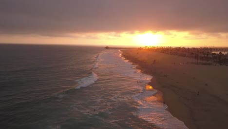 a flight over a southern california beach at sunset