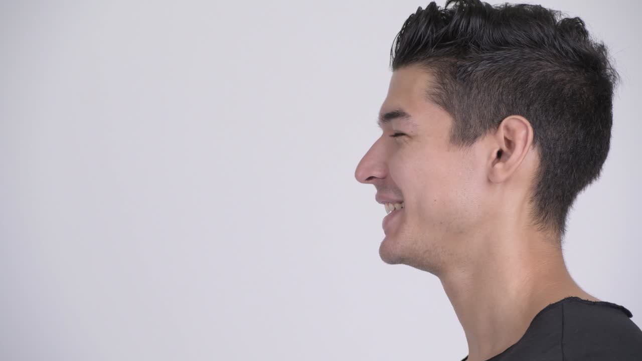 Closeup profile view of happy young handsome multi ethnic man