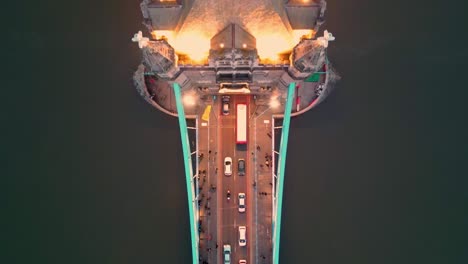 dolly in top-down shot of the tower bridge in london, at night