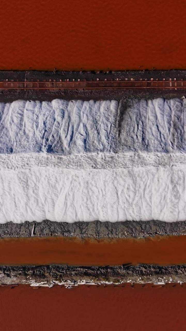 Salt mine located in red soil area producing minerals and salt piles