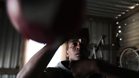 boxer punching a punching bag in the gym