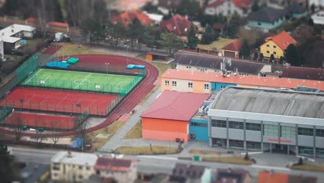 a miniatuarized tilt-shift view of the residential area with a school stadium in rudna town, czechia