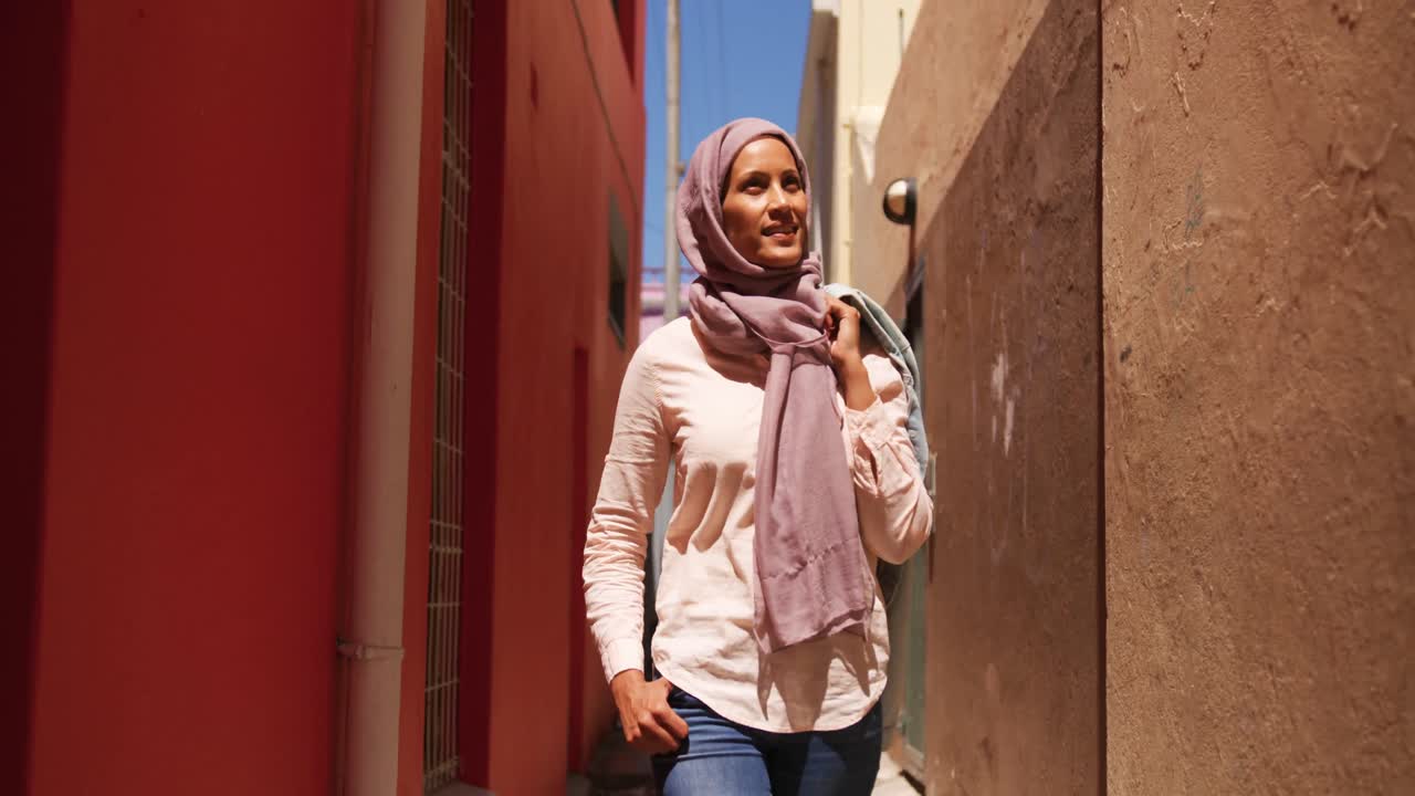 Young woman wearing hijab out and about in the city