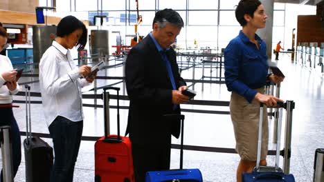 commuters standing in queue for check-in