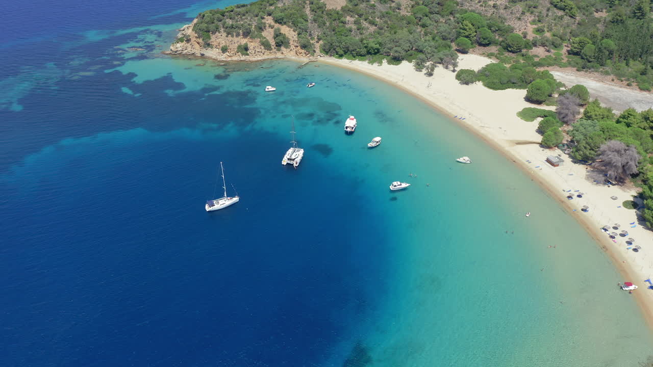 Aerial: Panoramic drone shot of Tsougria island beach near Skiathos, Sporades, Greece with amazing turquoise and emerald crystal clear water