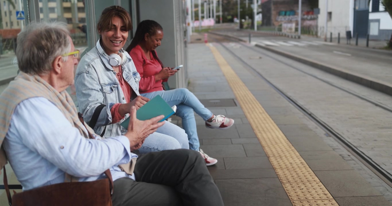 Diverse Group of People Waiting at a Tram Station