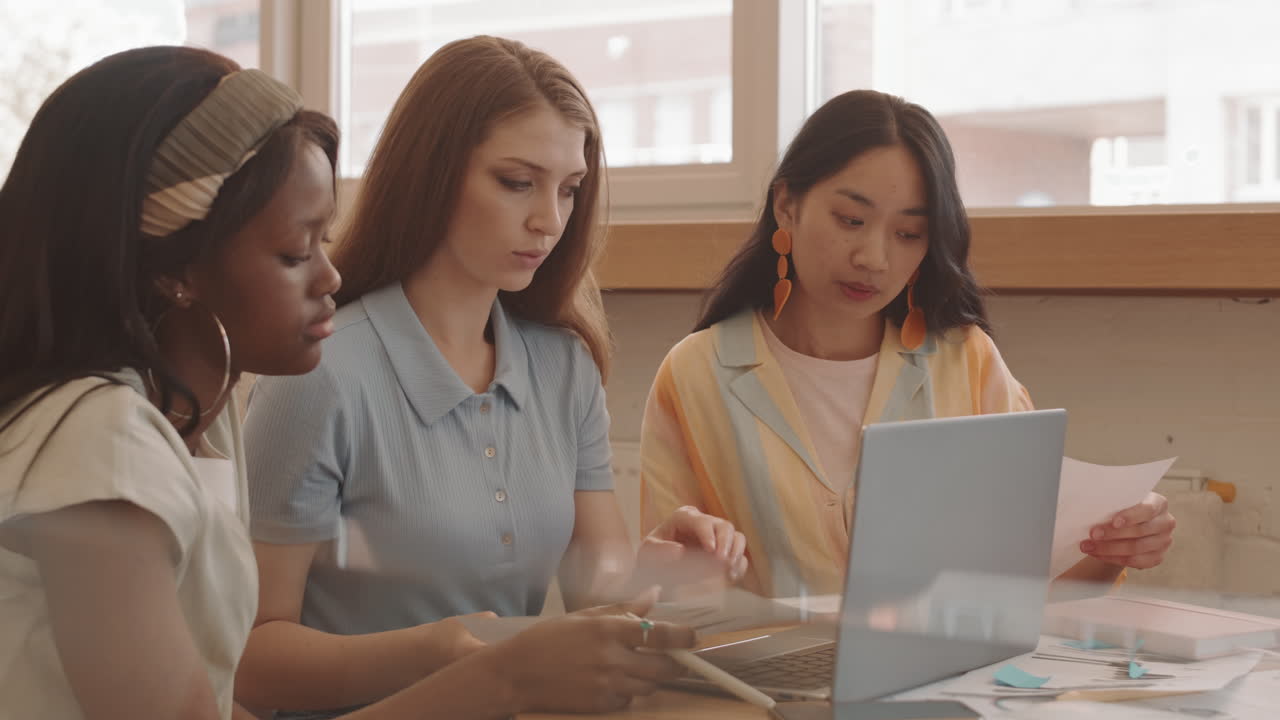 Young Women Working Together in Cafe
