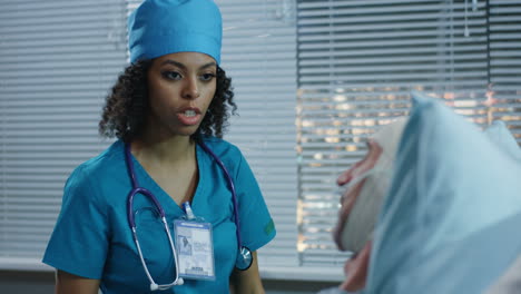 doctor consults with patient in hospital room