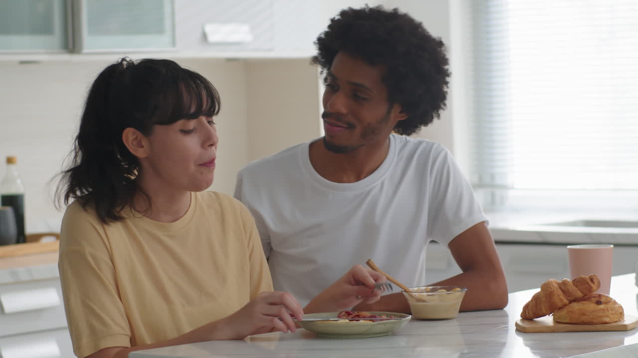 Happy Man Cuddling His Wife during Breakfast
