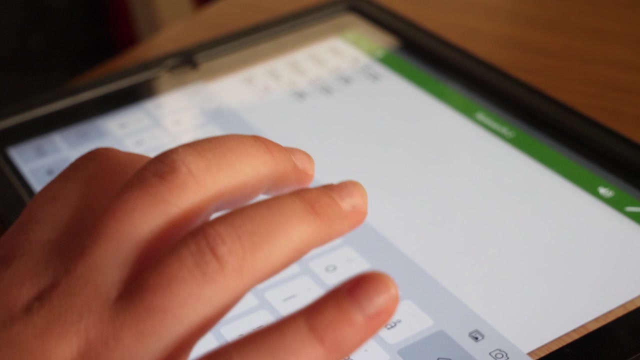 Child doing homework on a tablet
