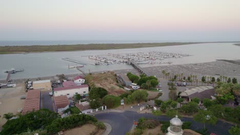 lighthouse and marina at sunrise