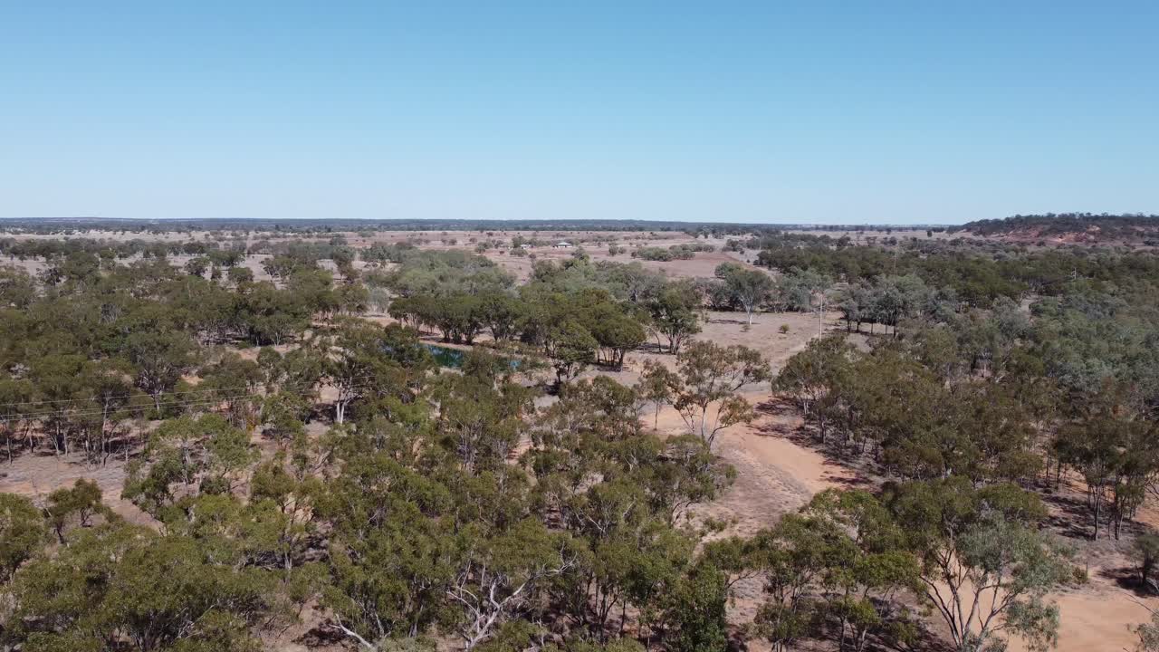 drone descendiendo sobre un paisaje desierto y un estanque de agua en el interior de australia