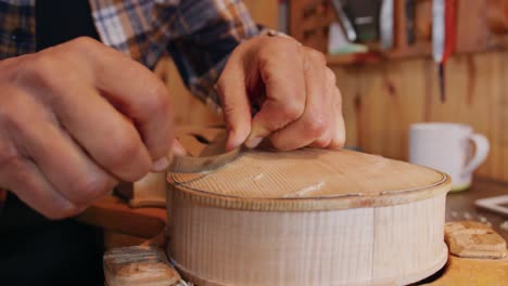 female luthier at work in her workshop