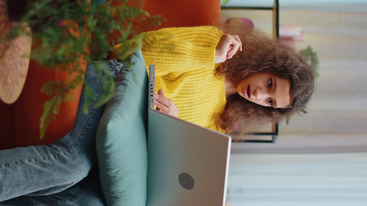 Teen child girl looking at laptop camera making video webcam conference call with friends family