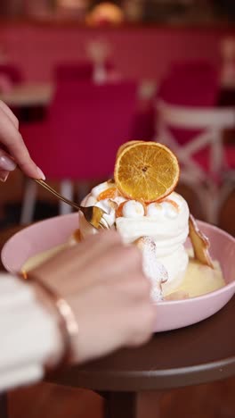 eine frau isst ein schönes geschichtetes dessert