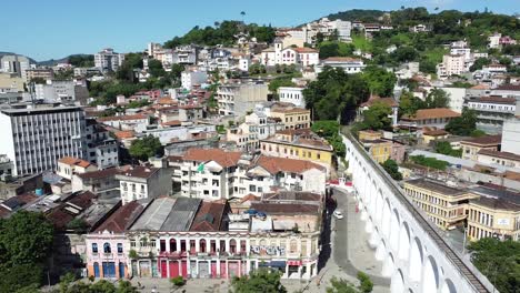 Arcos-da-Lapa,-historical-buildings-and-the-view-of-the-sea-from-at-Rio-de-Janeiro-downtown---drone-continuous-shot