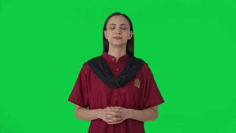 Happy-Indian-female-hotel-staff-listening-to-someone-Green-screen