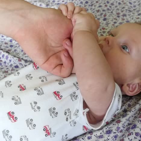 father holding baby hand
