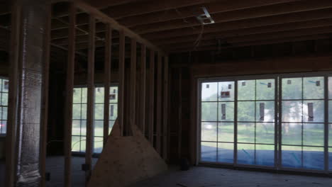 panning shot of of open area showing rooms in residential construction site