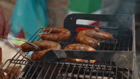 alheira sausages sizzling on open grill