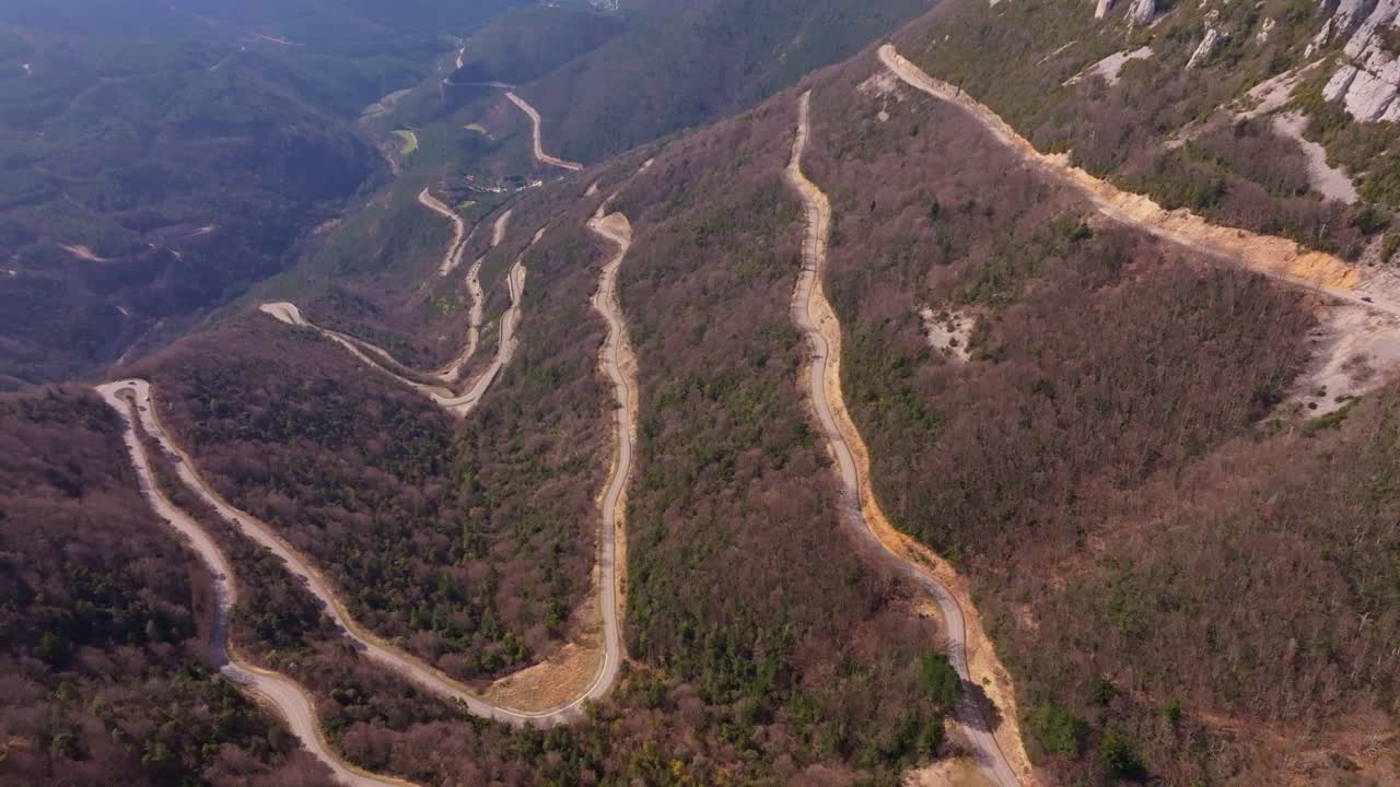 Drone glides above French pass with sharp rock slopes