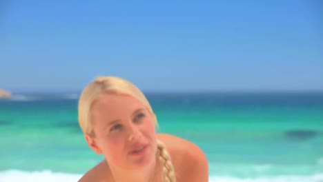 Attractive-blonde-woman-playing-with-a-beach-ball