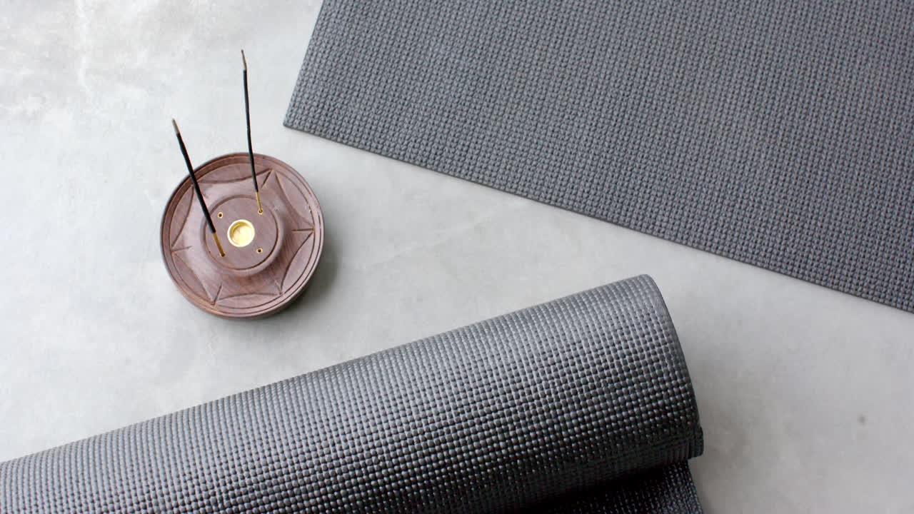 Yoga mats and incense holder creating peaceful home meditation space